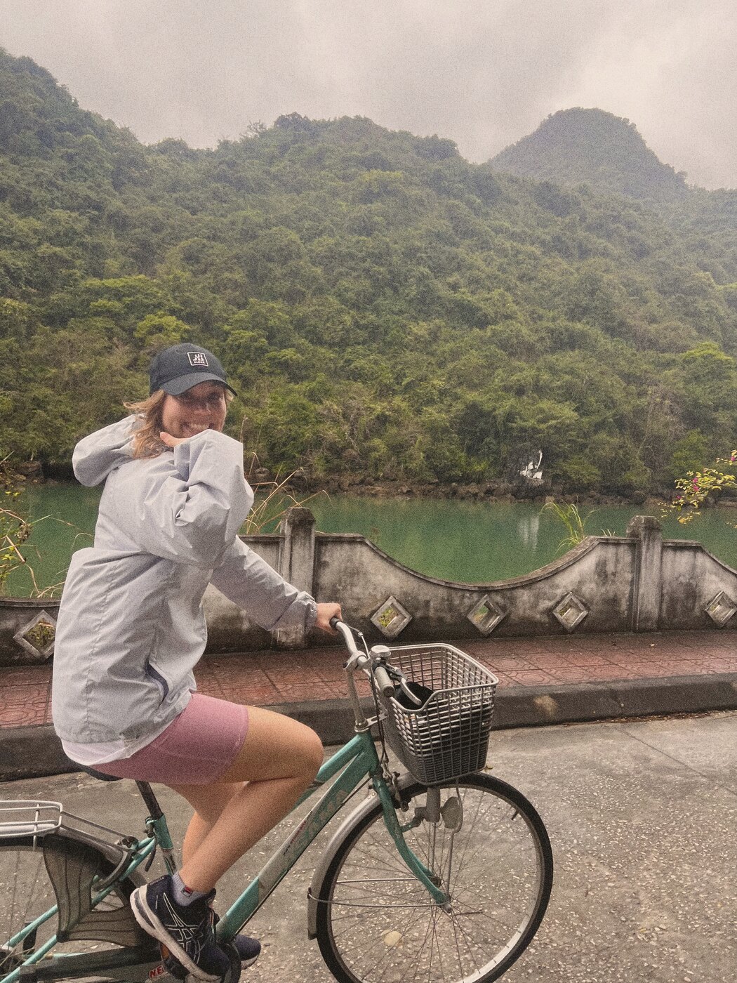 Cycling past a green lake