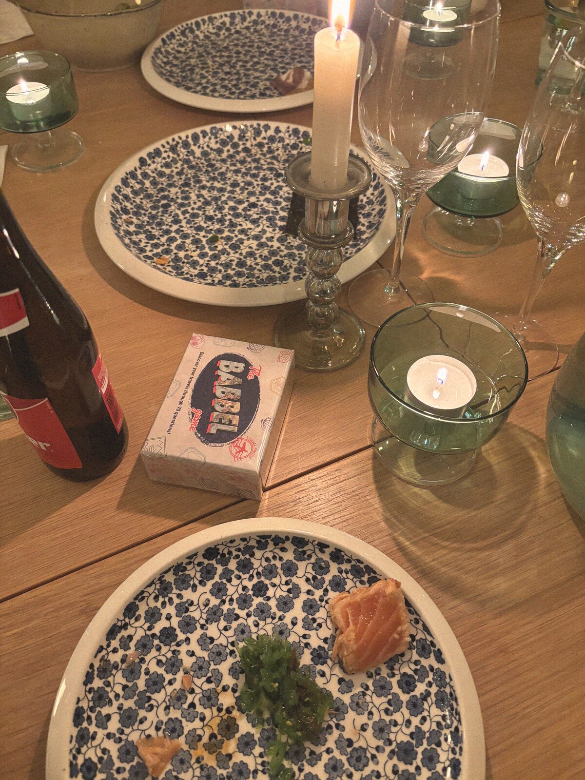 The Babbel Game box on a candlelit dinner table