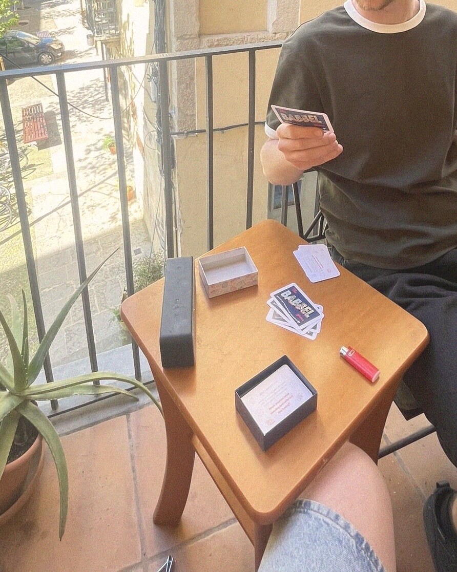Babbel cards spread out on a small wooden balcony table